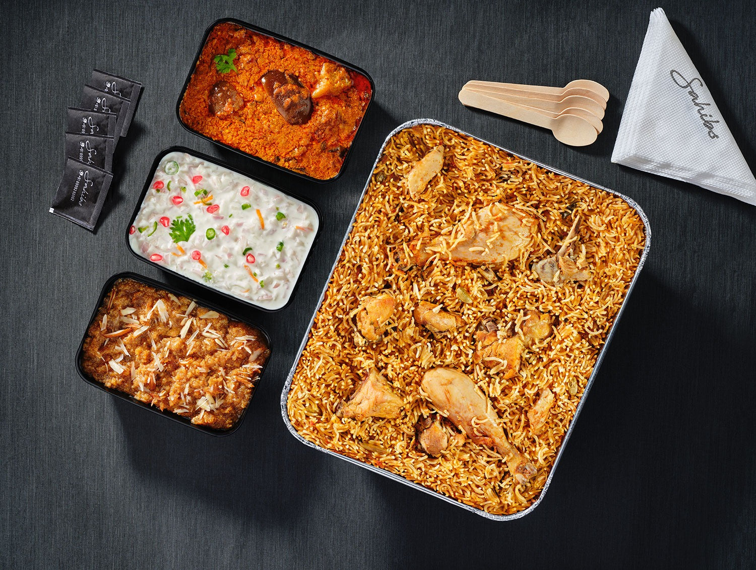 Chennai wedding-style shum biryani with tender chicken, brinjal thokku, creamy raita, and sweet bread halwa — traditional South Indian feast for 5